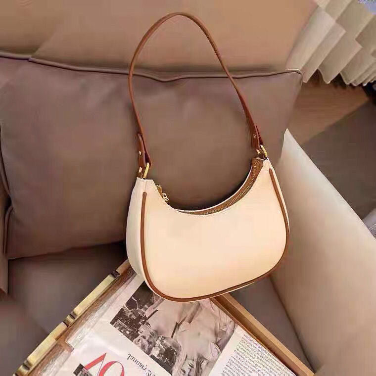 Lady crescent bag slung across one shoulder