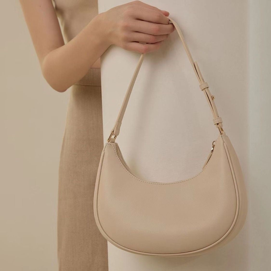 Lady crescent bag slung across one shoulder