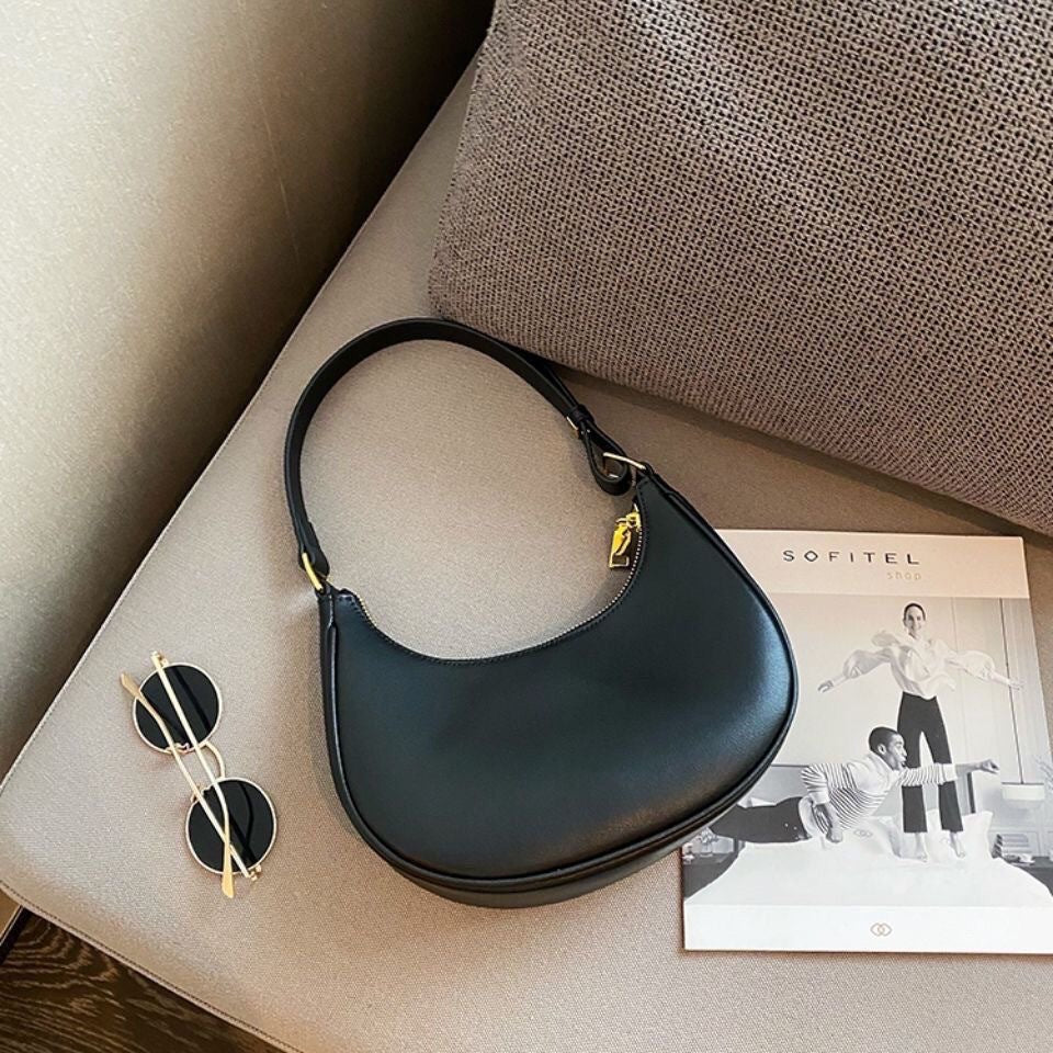Lady crescent bag slung across one shoulder