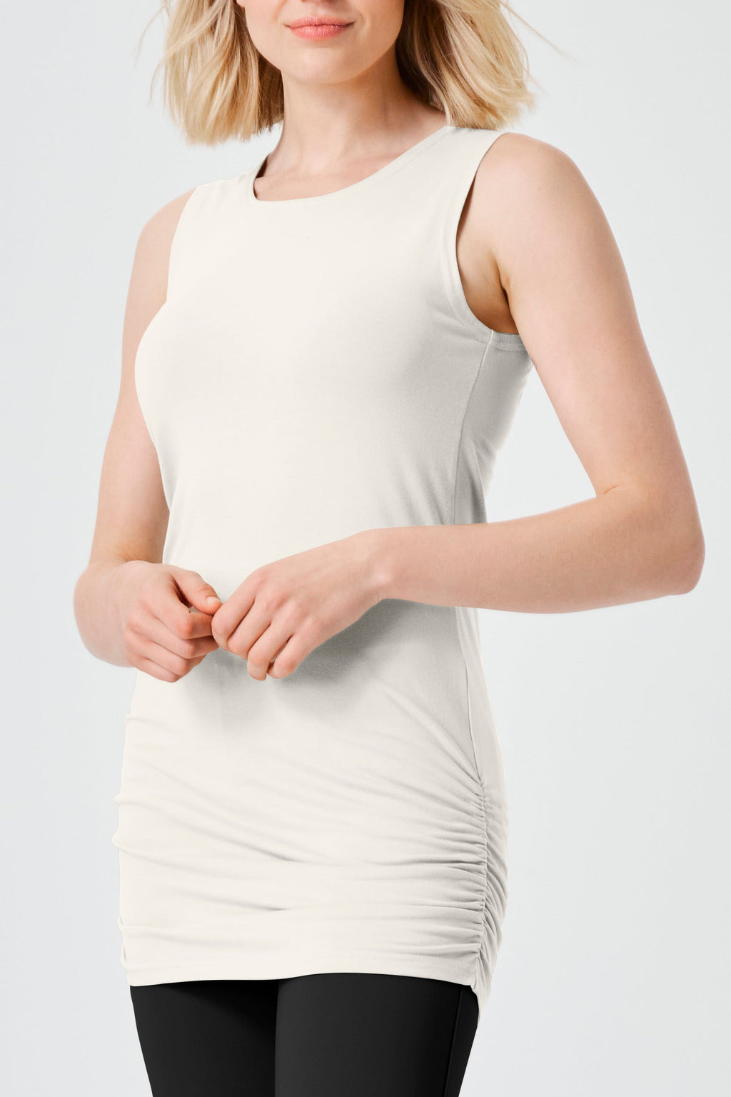 Model wearing a stylish ruched cotton tank top in vanilla color, perfect for modern women's fashion.