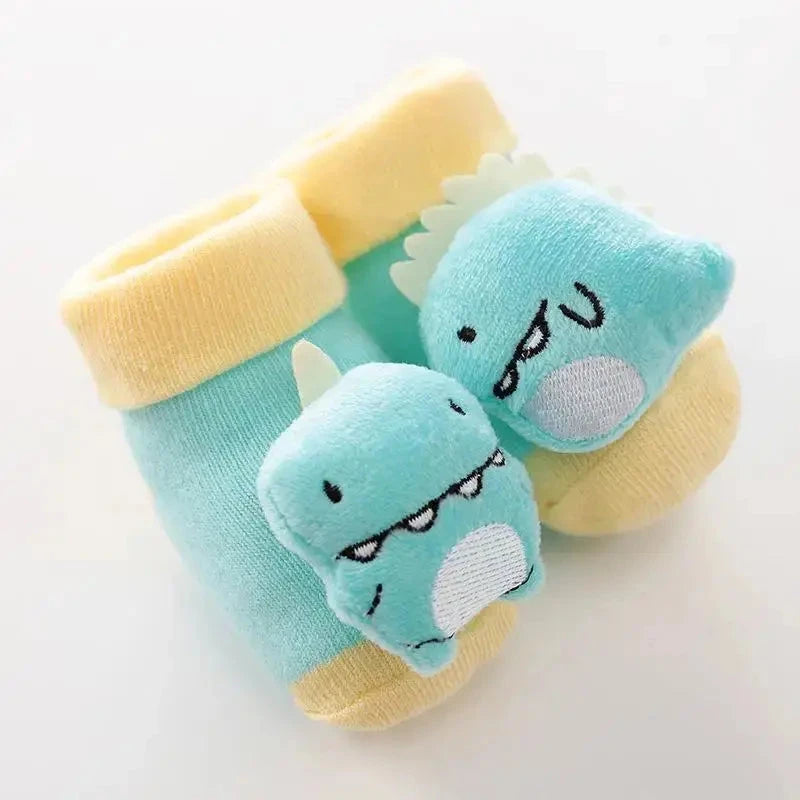 Cute cartoon baby anti-slip socks with rattle, cotton infant shoes for boys and girls, ideal for first steps and warm autumn wear.