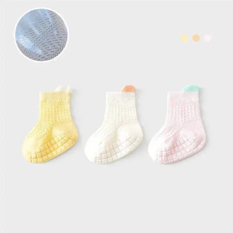 Three pairs of SHOPEZRA L.L.C. baby girl cotton socks in assorted colors, breathable mesh and non-slip soles for infants and kids.