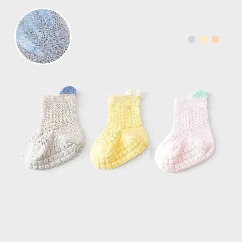 Set of three pairs of breathable, non-slip baby girl cotton socks in various colors, featuring mesh design for infants and kids.