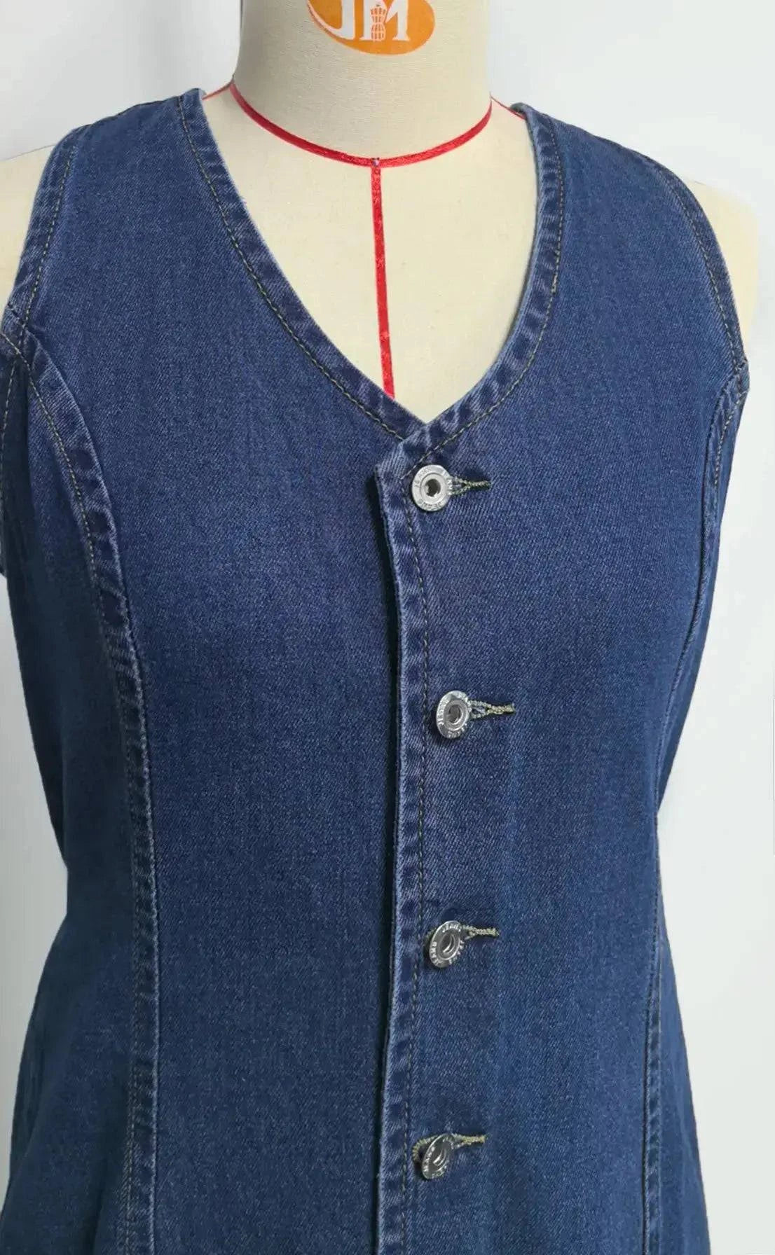 Women's mid-length denim dress by SHOPEZRA L.L.C. featuring sleeveless design, V-neck, tight waist, and stylish splice details.
