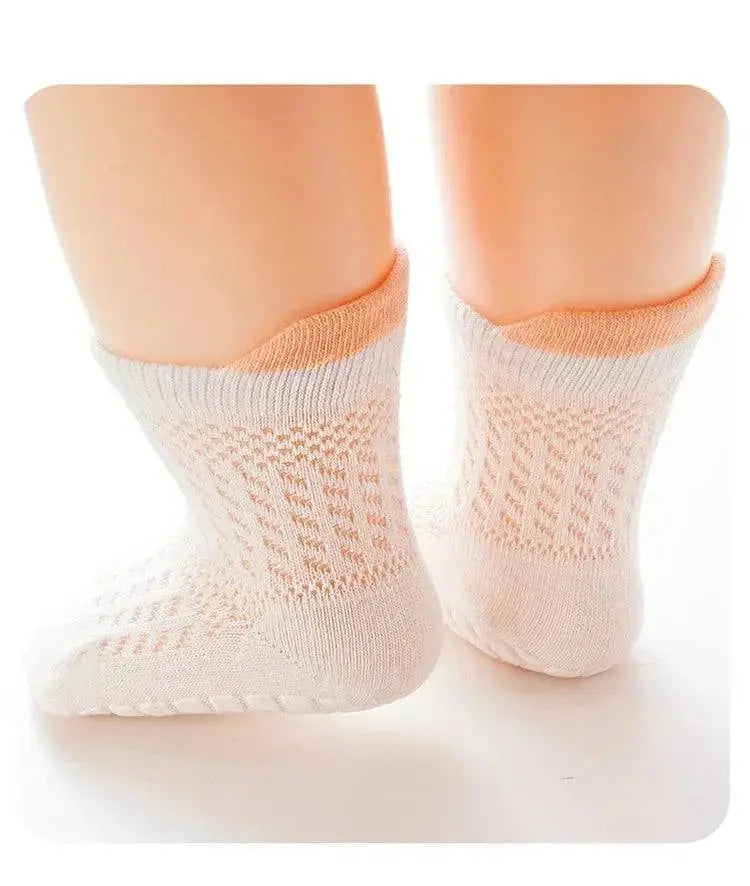 Three pairs of breathable, non-slip baby girl cotton socks in various colors, designed for infants and kids with mesh details.