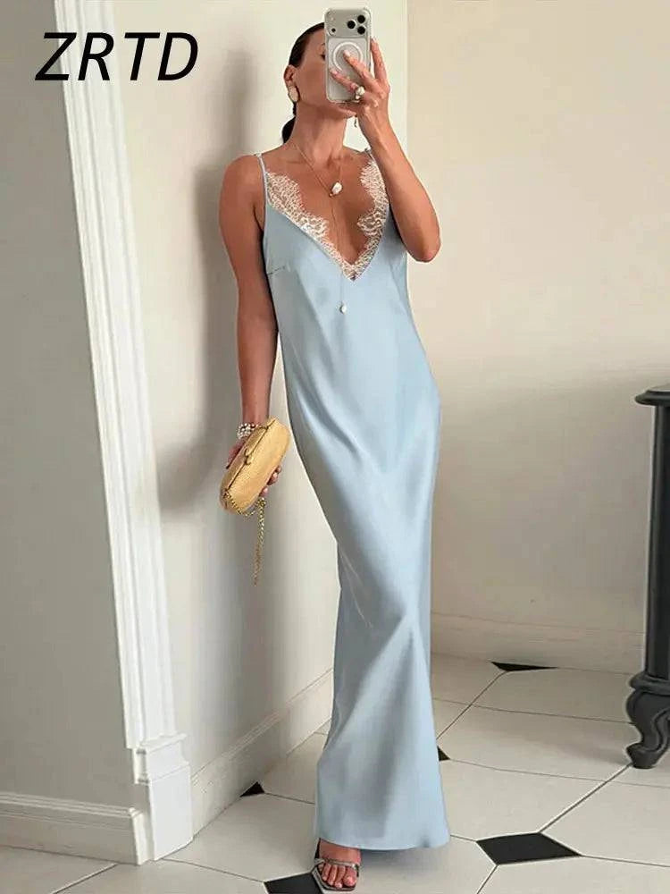 Elegant white satin and lace sleeveless summer dress with V-neck, backless design and flowing skirt, perfect for beach parties.