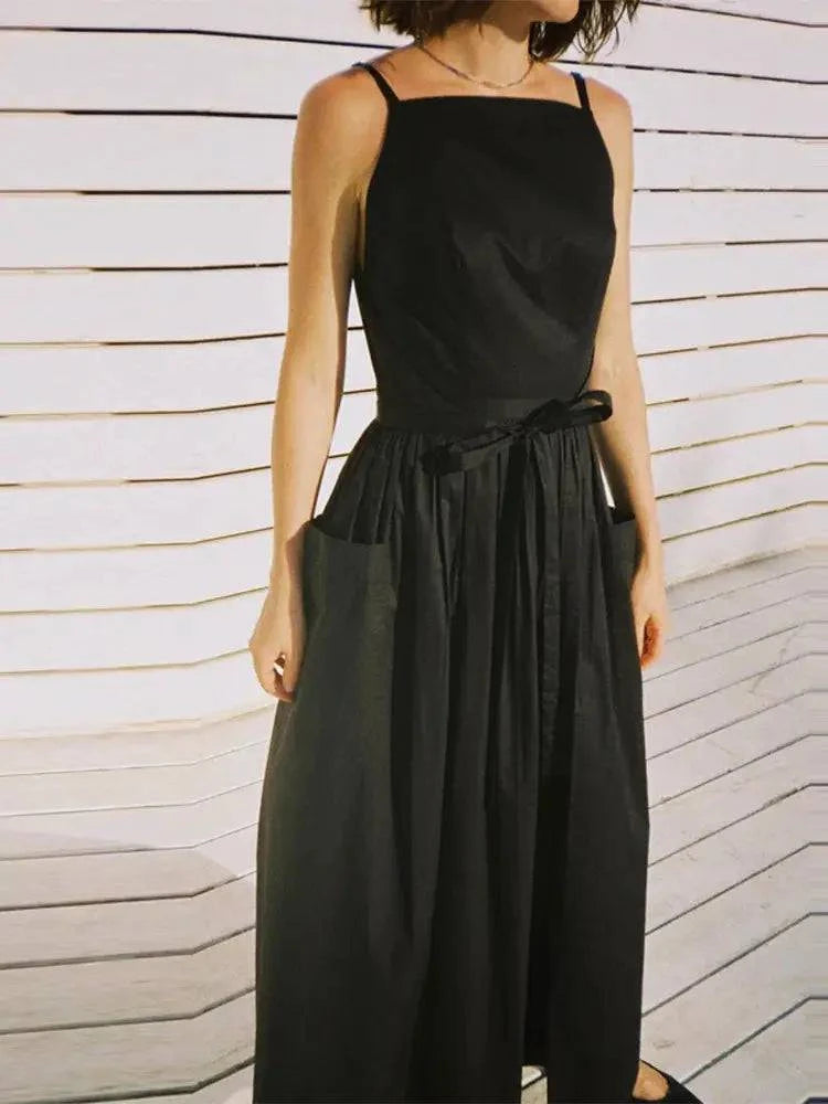 Elegant beige sleeveless pleated dress with square neckline, high waist, and spaghetti straps, ideal for daily wear and dates.