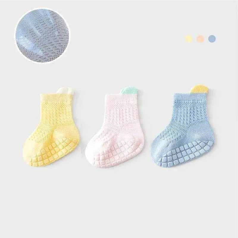 Set of three pairs of colorful, breathable non-slip baby girl cotton socks with mesh design, perfect for infants and kids.