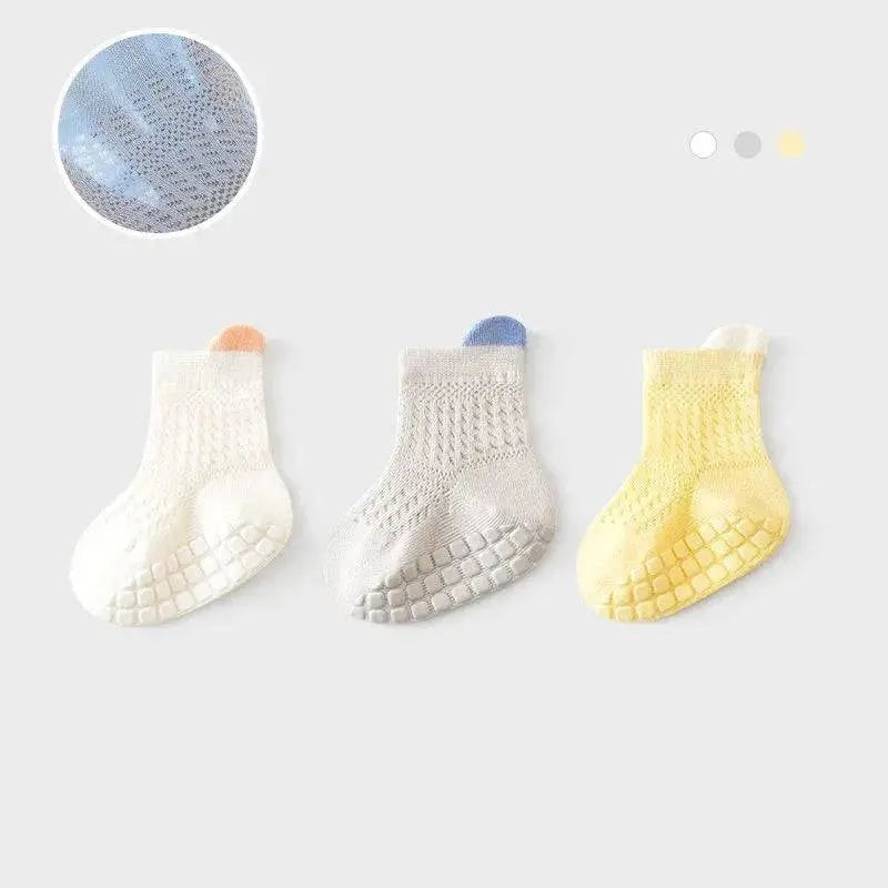 Set of three pairs of breathable, non-slip baby girl cotton socks in various colors, suitable for infants and kids.