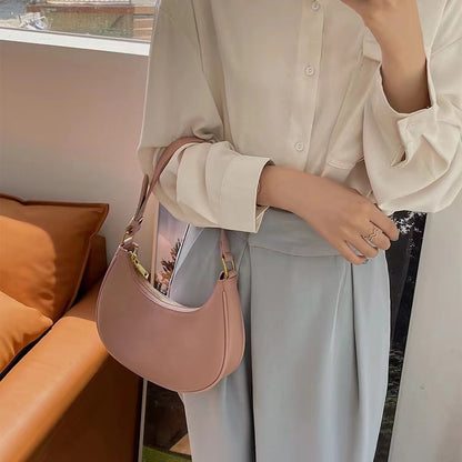Lady crescent bag slung across one shoulder