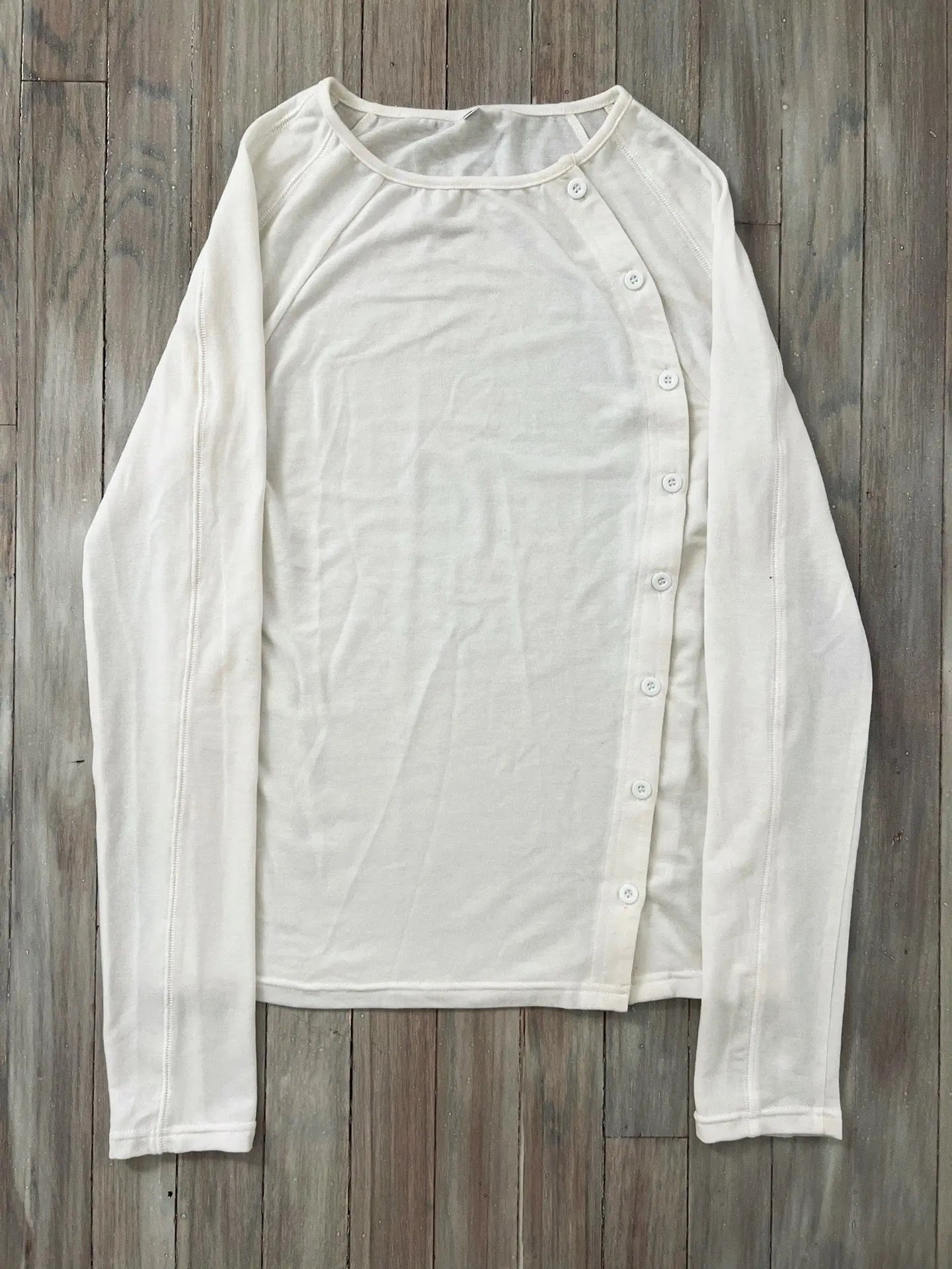 Black long-sleeved button T-shirt with crew neck by Dropshipman, made from soft fabric, displayed flat on a white background.