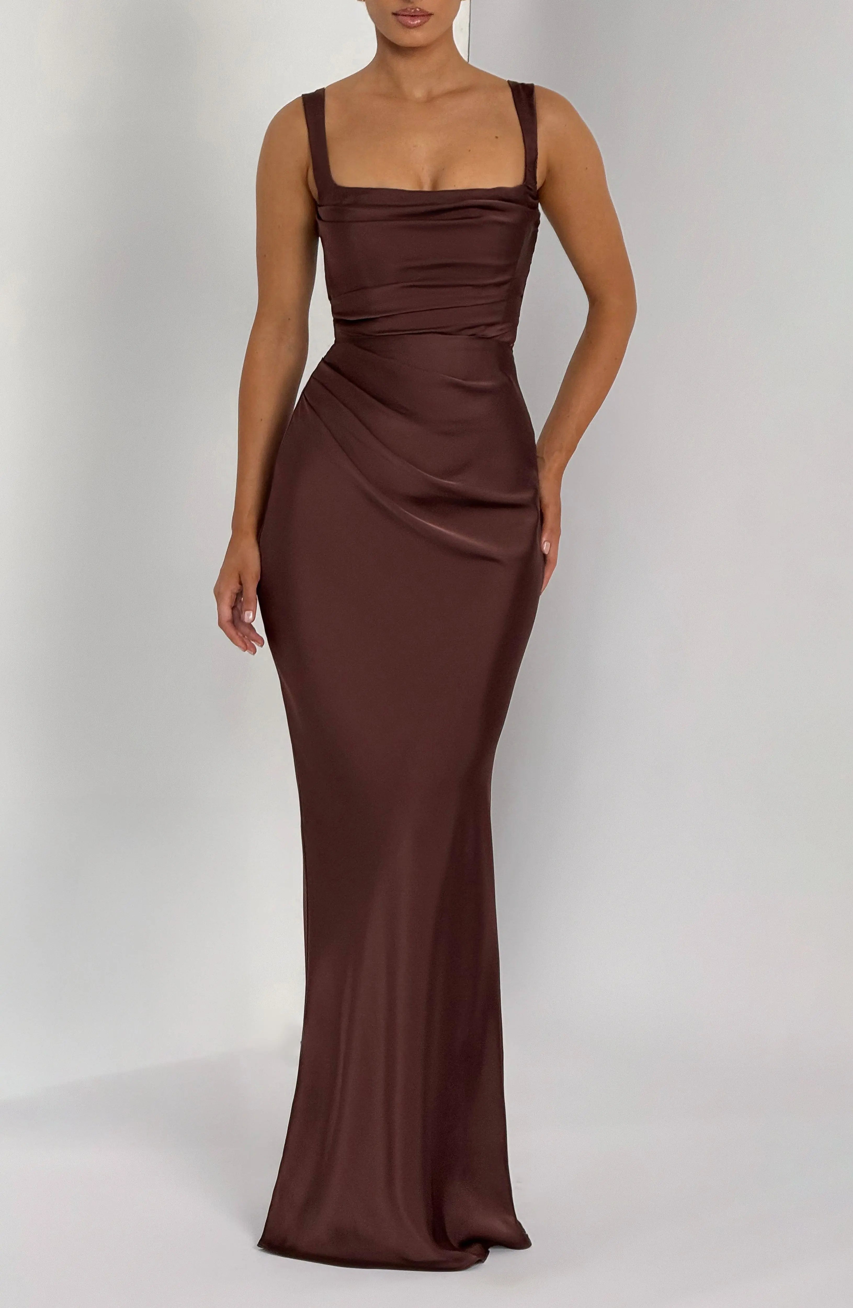 Calanthe Maxi Dress in plum brown by Dropshipman, flowing fabric with a stylish design, shown on a model.