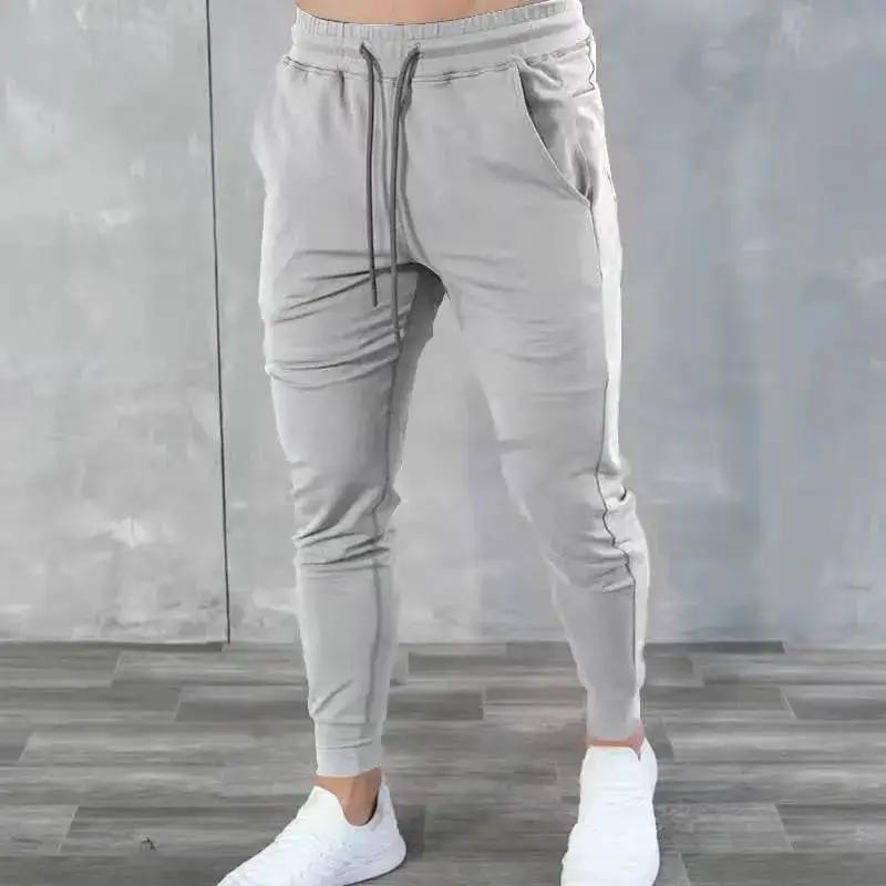 Light blue Korean version slim fit men's fitness jogger pants by Dropshipman, featuring a comfortable tapered design and elastic waistband.
