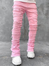 Pink ripped jeans for men with fringes, patched details, long tight fit, and stacked style, by Dropshipman.