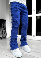 Pink ripped jeans for men with fringes, patched details, long tight fit, and stacked design from Dropshipman.