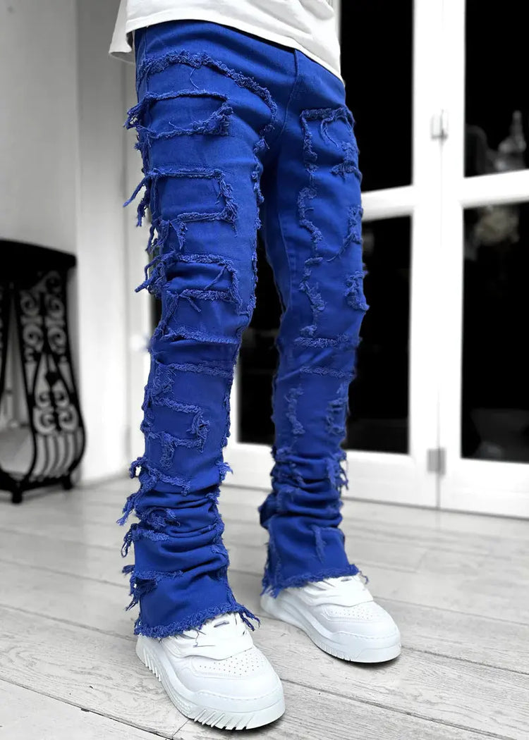 Pink ripped jeans for men with fringes, patched details, long tight fit, and stacked design from Dropshipman.