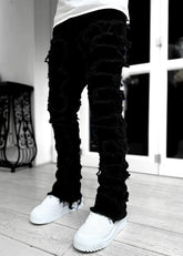 Pink ripped jeans with fringes, patched details, and a long, tight-fit stacked design for men&