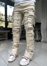 Pink ripped jeans for men with fringes, patched details, long tight fit, and stacked style, by Dropshipman.