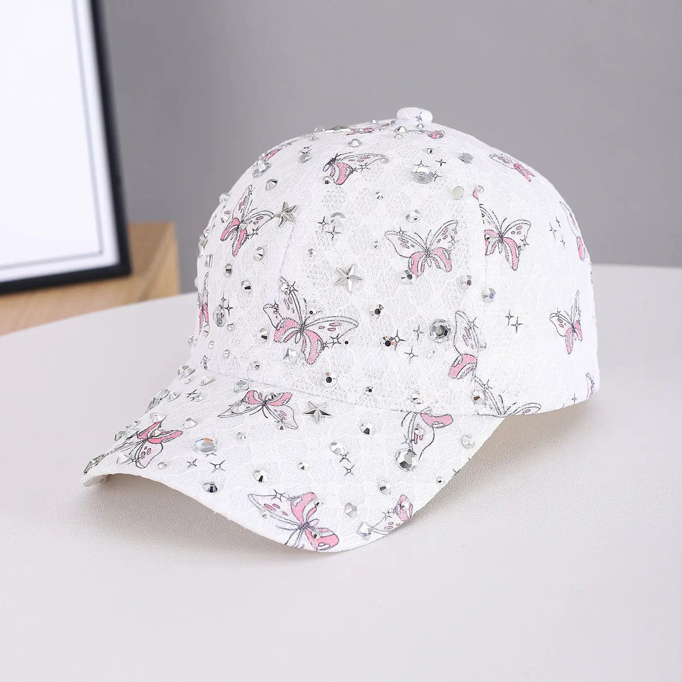 Lady's lace butterfly silver diamond star accessory on a street style baseball cap, suitable for outdoor wear and casual outings.