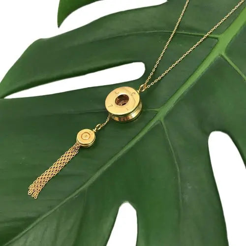 Ezra Bullet Tassel Necklace made of recycled brass featuring artisan craftsmanship and a bold statement design.
