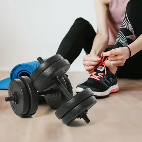 Pair of Ezra Soozier 42lb dumbbells for biceps training and fitness exercises, shown with weights and handles.