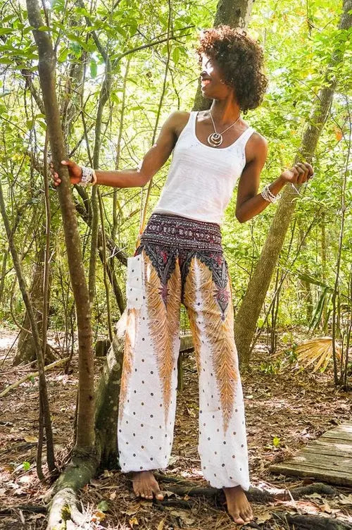 White peacock Harem pants by Ezra, boho yoga and festival pants with relaxed fit and intricate peacock print detail.
