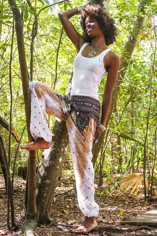 Ezra white peacock harem pants, boho yoga and festival pants with wide legs and intricate peacock feather design.