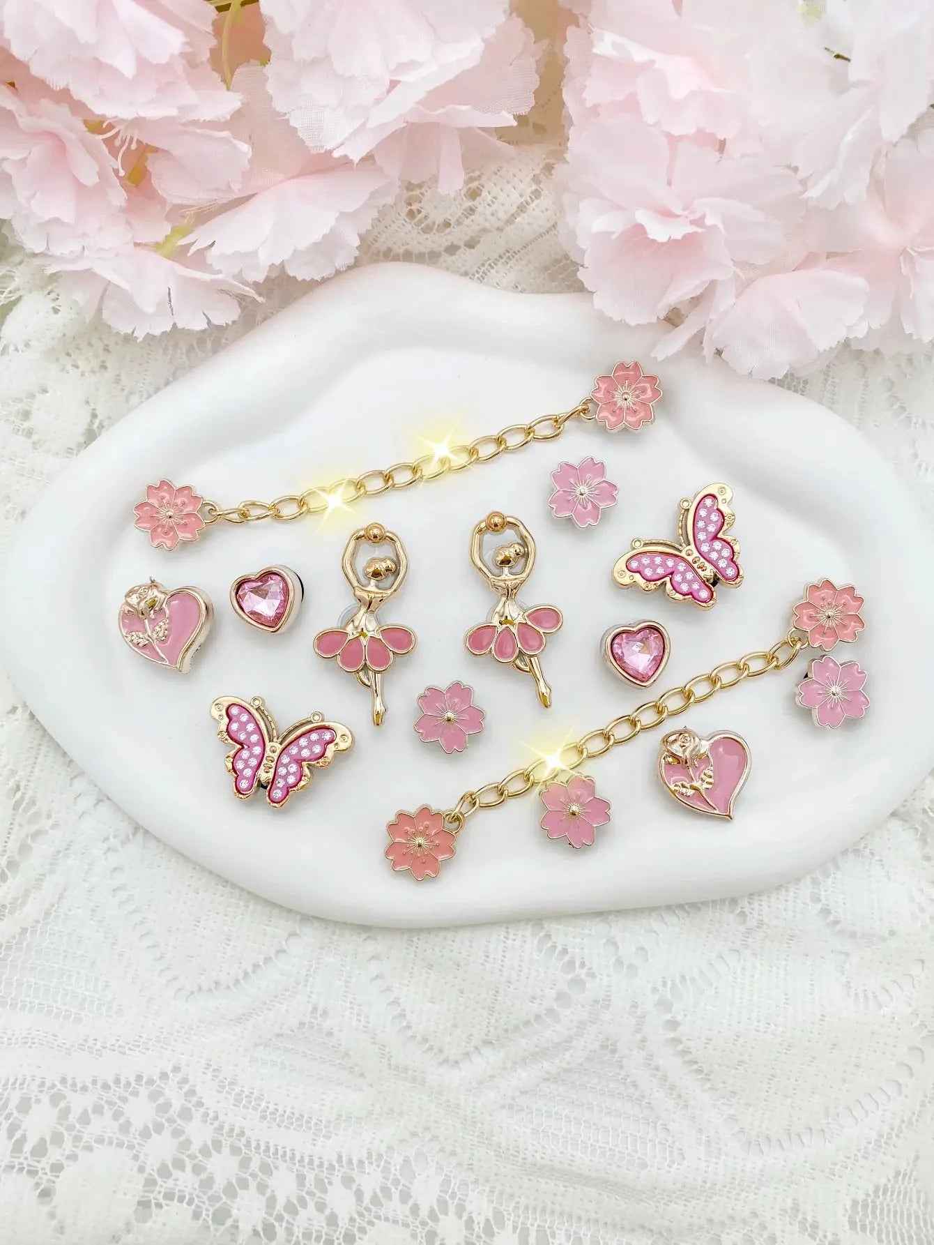 14pcs fashion ABS shoe charms featuring pink flowers, butterflies, hearts, and flower chains for DIY sandal decorations.