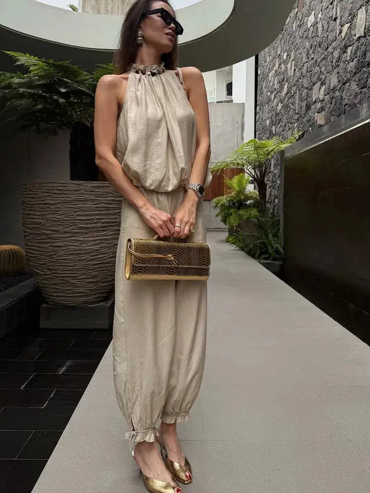 Beige beaded halter neck bubble top with high-waist wide-leg pants, summer casual linen blend outfit, perfect for resort or office wear.