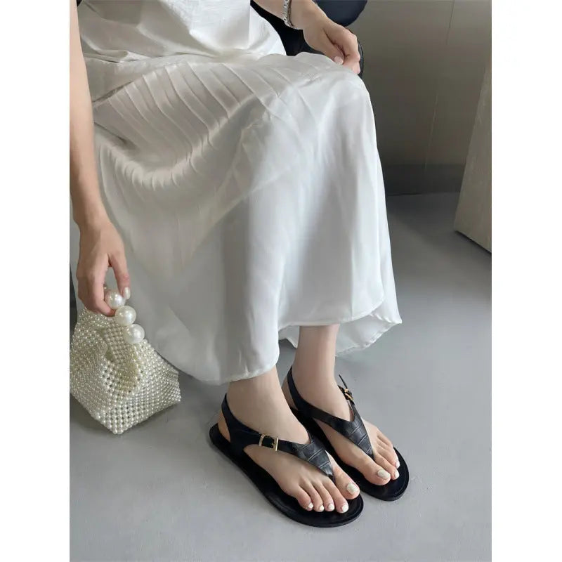 Black women's summer thong flat sandals with casual Roman style, featuring a comfortable slip-on design by SHOPEZRA L.L.C.