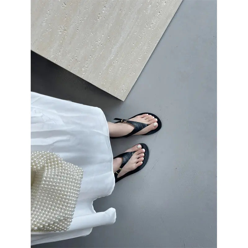 Black women's summer thong flat sandals featuring casual Roman-style design from SHOPEZRA L.L.C., suitable for European and American fashion.