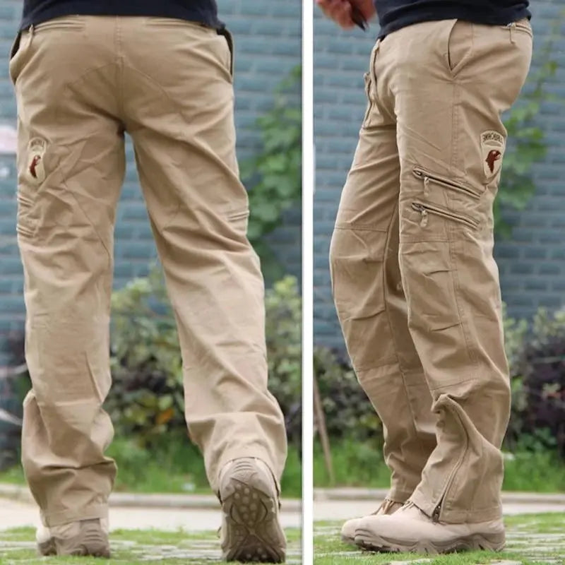 Men's tactical cargo pants in black and green camouflage with multiple pockets, durable cotton fabric, outdoors and work-ready style.