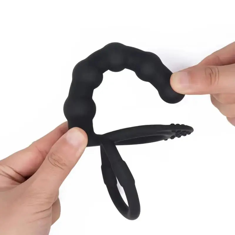 Black double penetration dildo with anal beads, butt plug, sex ring, and G-spot massager for men, designed for couples.