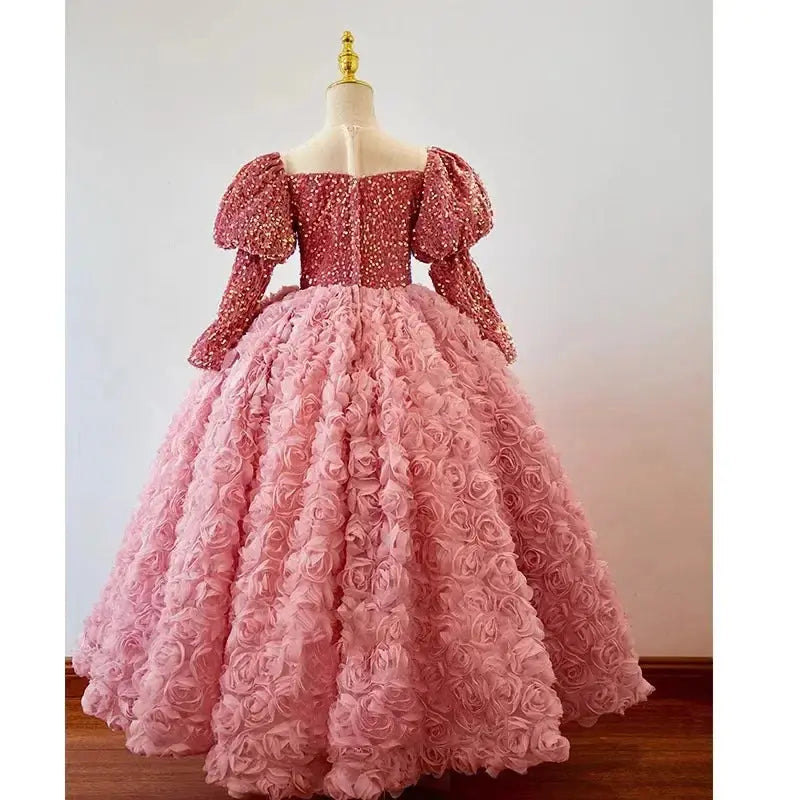 Pink children's princess dress with shiny fabric, long sleeves, suitable for birthday, banquet, or piano performance for girls.
