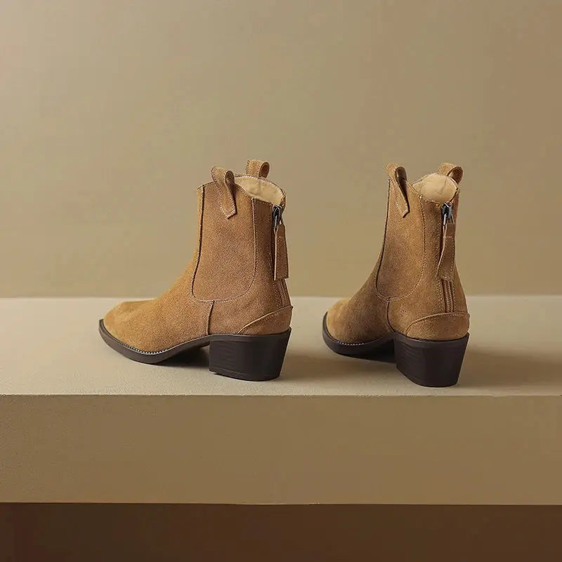 Black and brown cow suede Western ankle boots for women with pointed toes, mid block heels, back zipper, and plush lining.