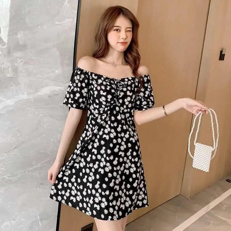 Black floral off-shoulder Daisy Dress by SHOPEZRA L.L.C., slim-fit summer dress with a trendy, elegant design for 2024.