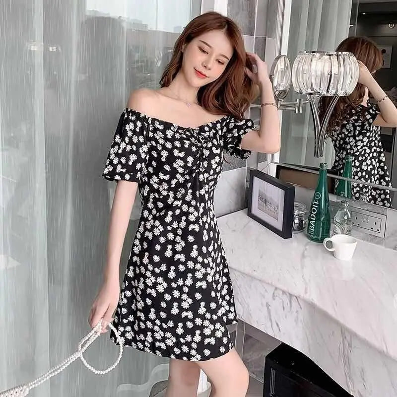 Black slim-fit off-shoulder floral dress by SHOPEZRA L.L.C. for summer 2024, featuring a daisy pattern and trendy style.