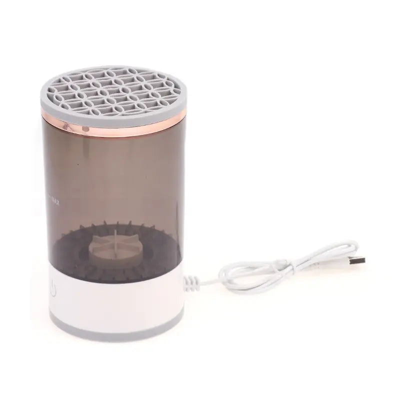 Black rechargeable makeup brush cleaner by SHOPEZRA L.L.C., showing the compact device with brush attachments.