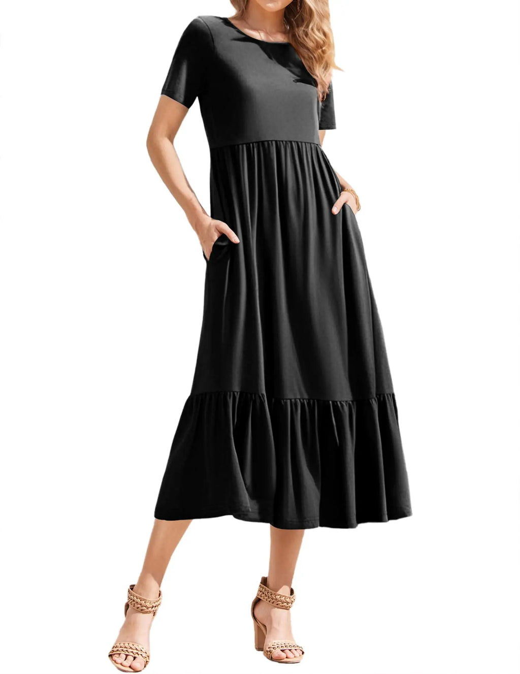 Curvy woman wearing a black summer midi dress with pockets, short sleeves, and tiered design for vacation style.