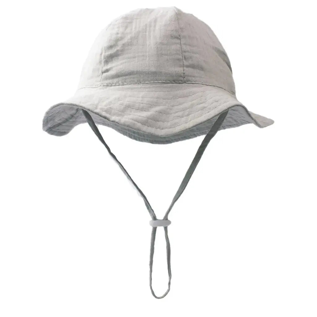Baby cotton bucket hat with colorful print, unisex beach cap for boys and girls, sun protection for ages 3-12 months.