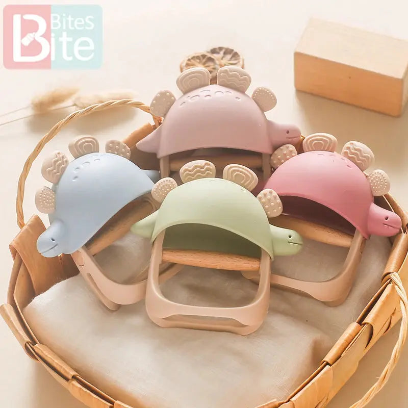 Blue baby silicone teether dinosaur gloves with rattles, suitable for 0-12 months, designed for dental and oral comfort.