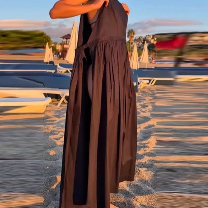 Brown sleeveless pleated dress with square neck, lace-up detail, high waist, and spaghetti straps, ideal for daily or date wear.