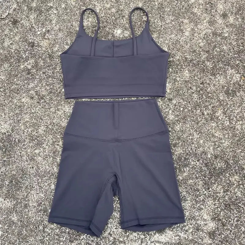 Purple women's yoga cycling shorts and U-shaped strap bra set, outerwear for gym, yoga, and sports activities.