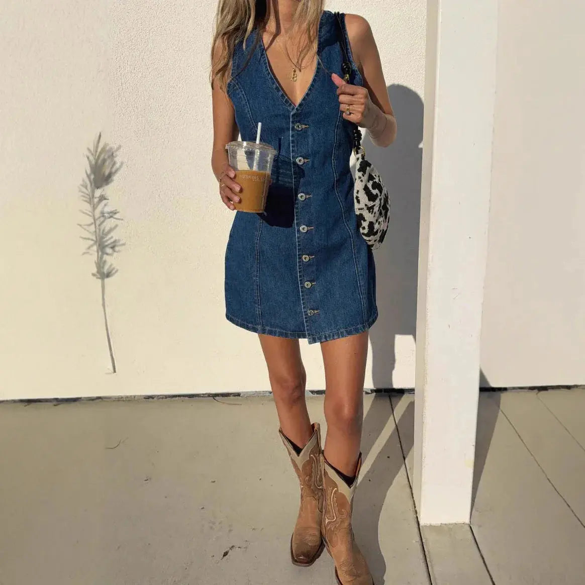 Dark blue denim sleeveless V-neck dress for women, mid-length, fitted waist, Y2K streetwear style, suitable for parties or work.