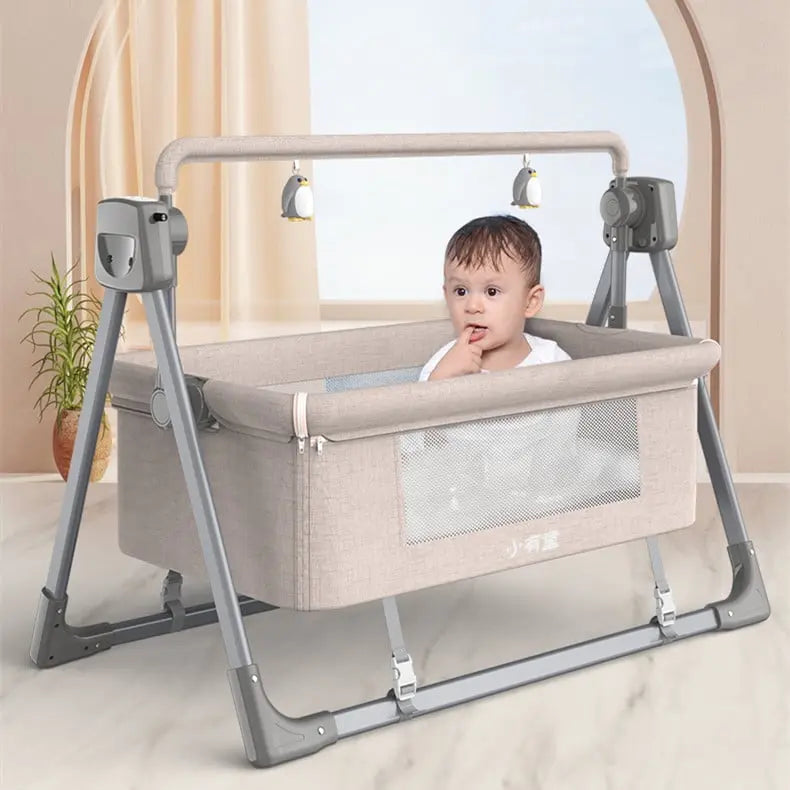 A baby comfortably seated in an intelligent electric cradle for infants with playful hanging toys.