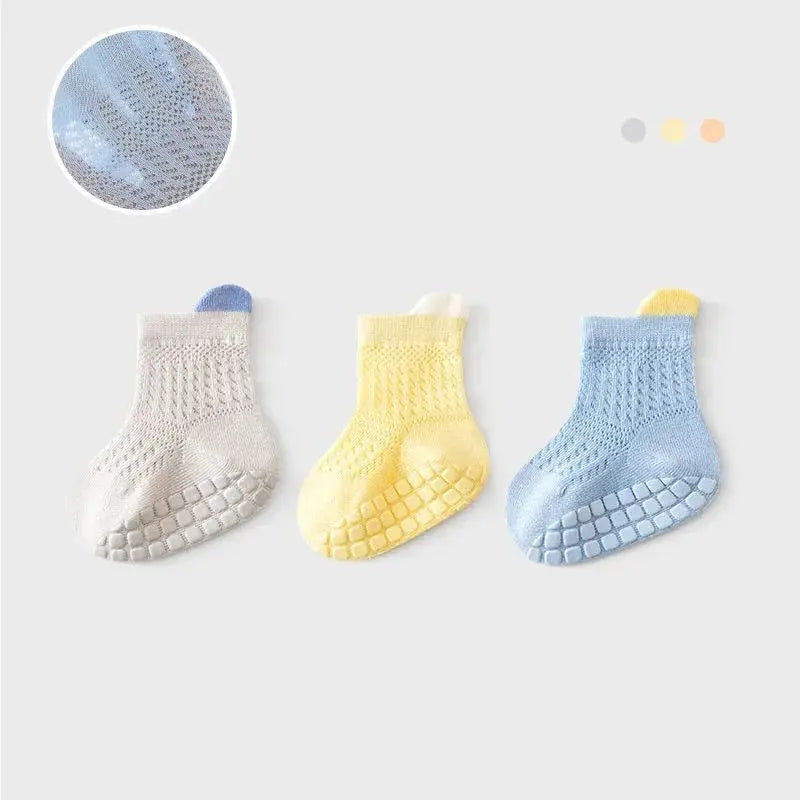 Set of three pairs of breathable, colorful non-slip baby girl cotton socks with mesh design for infants and kids.