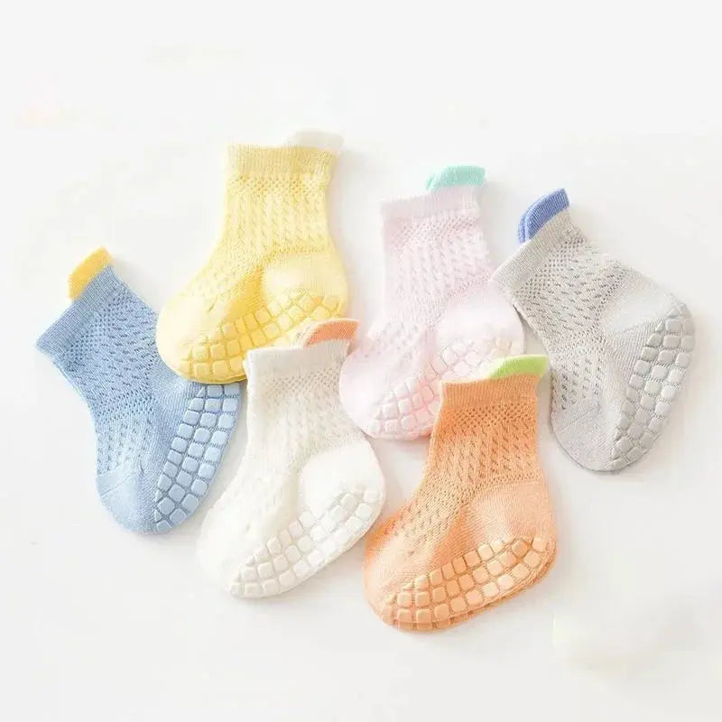 Three pairs of breathable, thin cotton baby girl socks in various colors with non-slip soles, suitable for infants and young children.