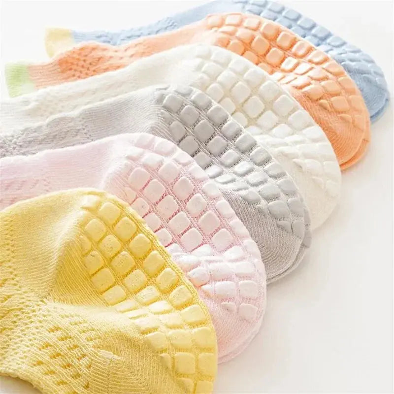 Set of three pairs of colorful, breathable cotton baby girl socks with non-slip soles, suitable for infants and toddlers.