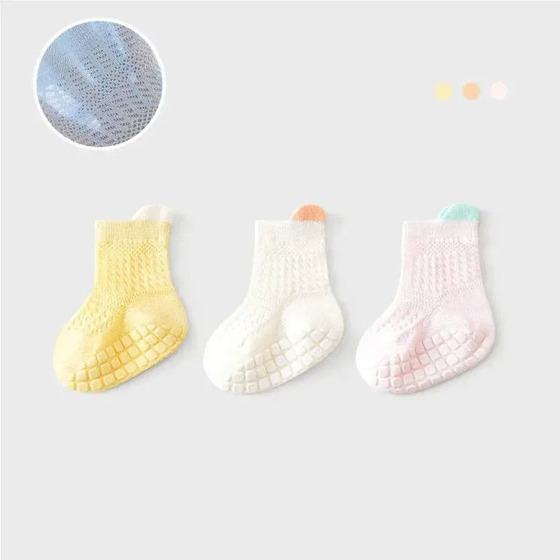 Three pairs of SHOPEZRA L.L.C. baby girl cotton socks in various colors, featuring non-slip soles and breathable mesh for infants and kids.