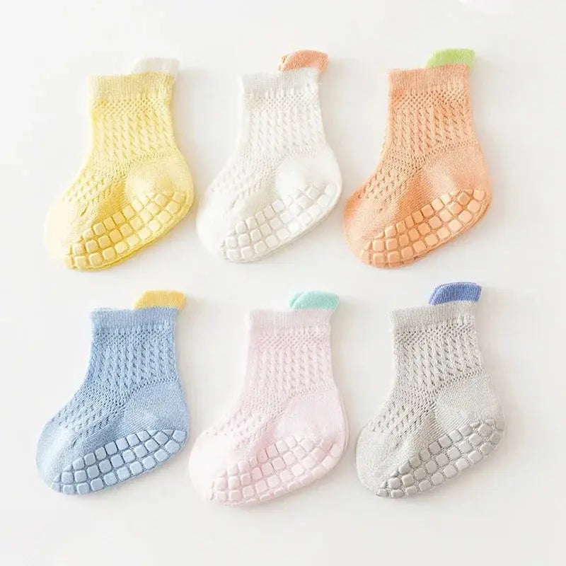 Three pairs of SHOPEZRA L.L.C. non-slip baby girl cotton socks in assorted colors, breathable and thin for infants and kids.